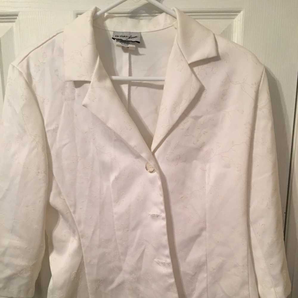 Woman’s white jacket, skirt and pants outfit
